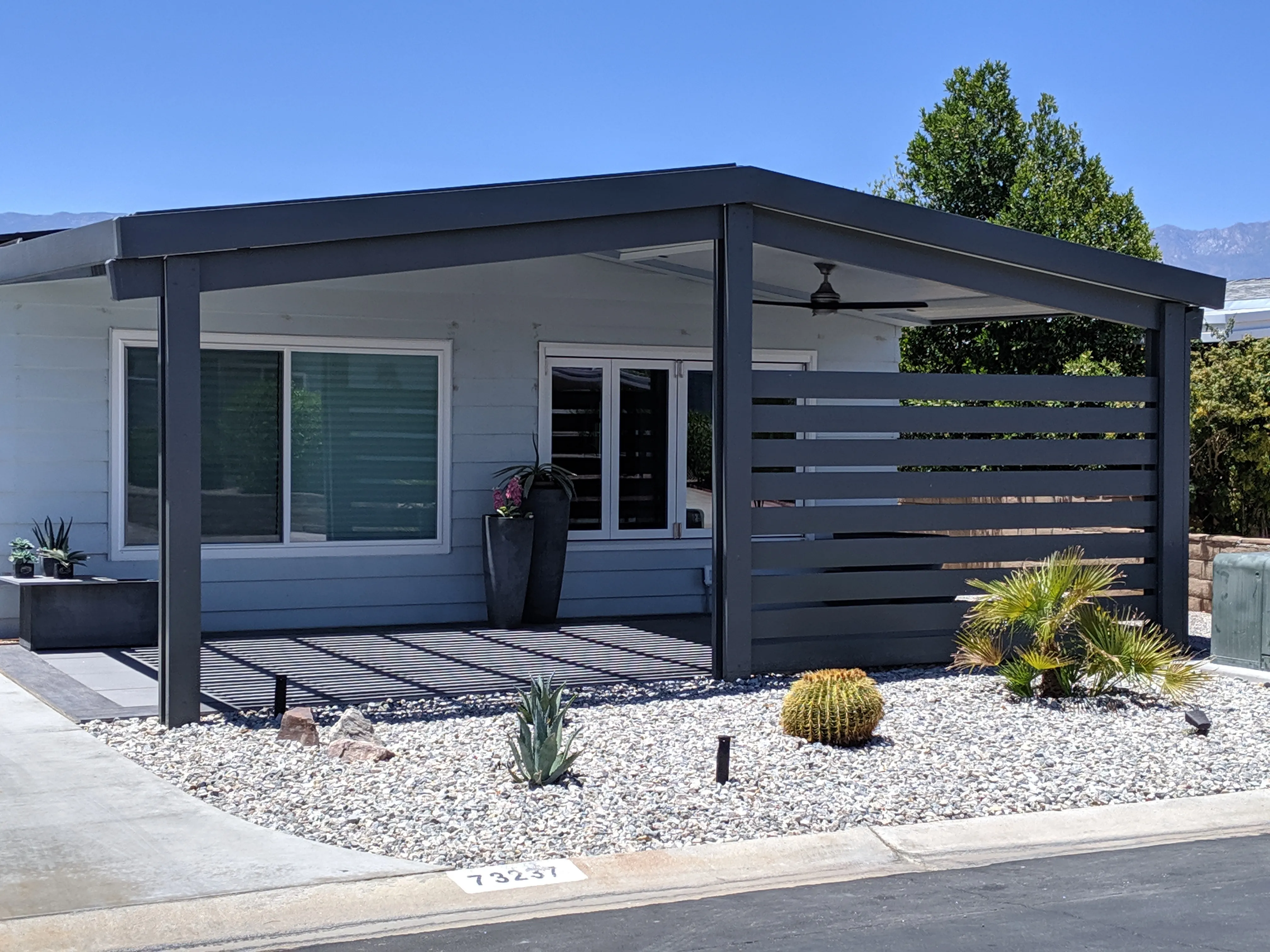 Duralum insulated patio cover with privacy wall for a backyard
