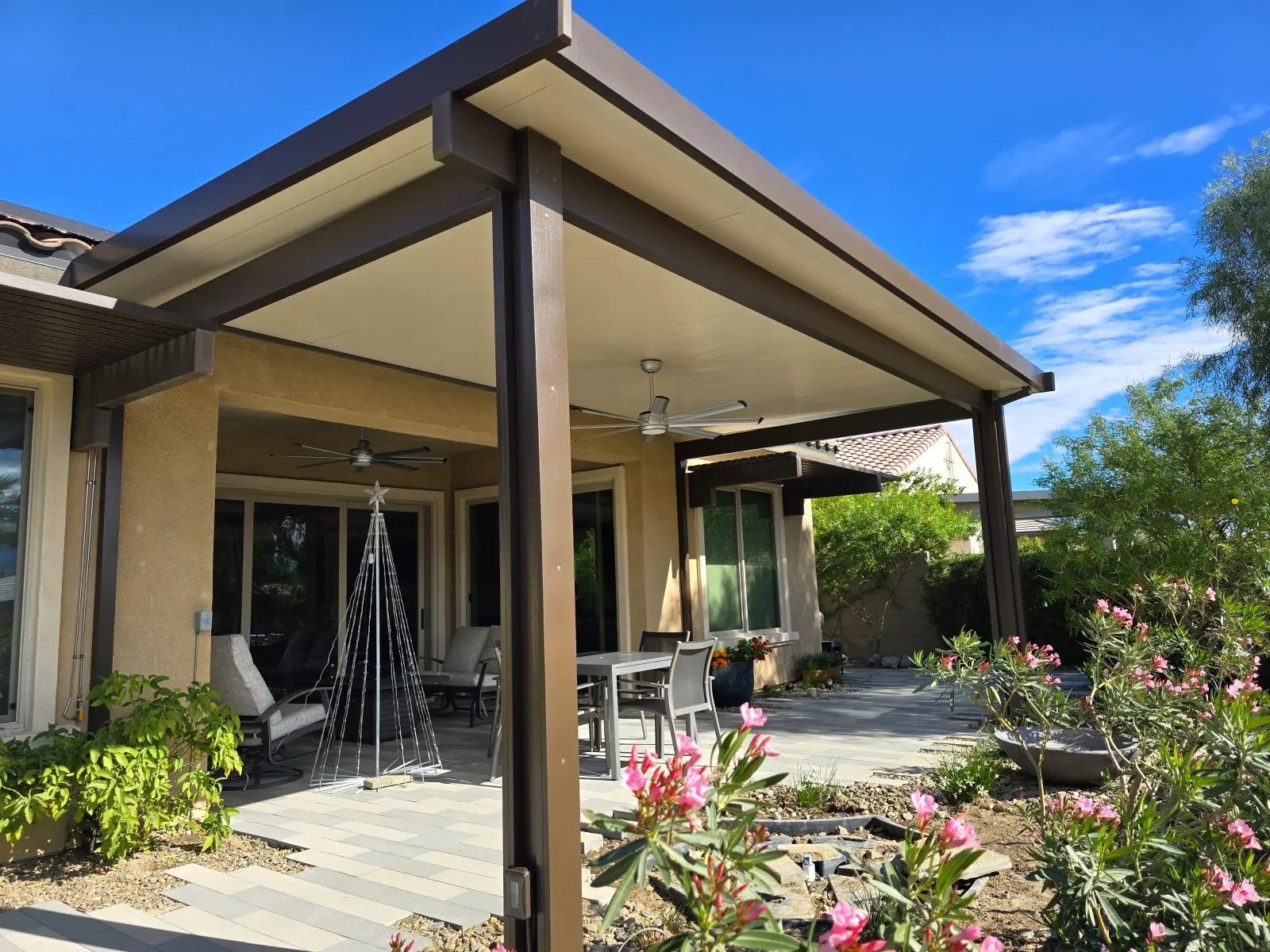 Weatherwood aluminum attached insulated patio cover in Siennawood and Sandalwood on a DFW home