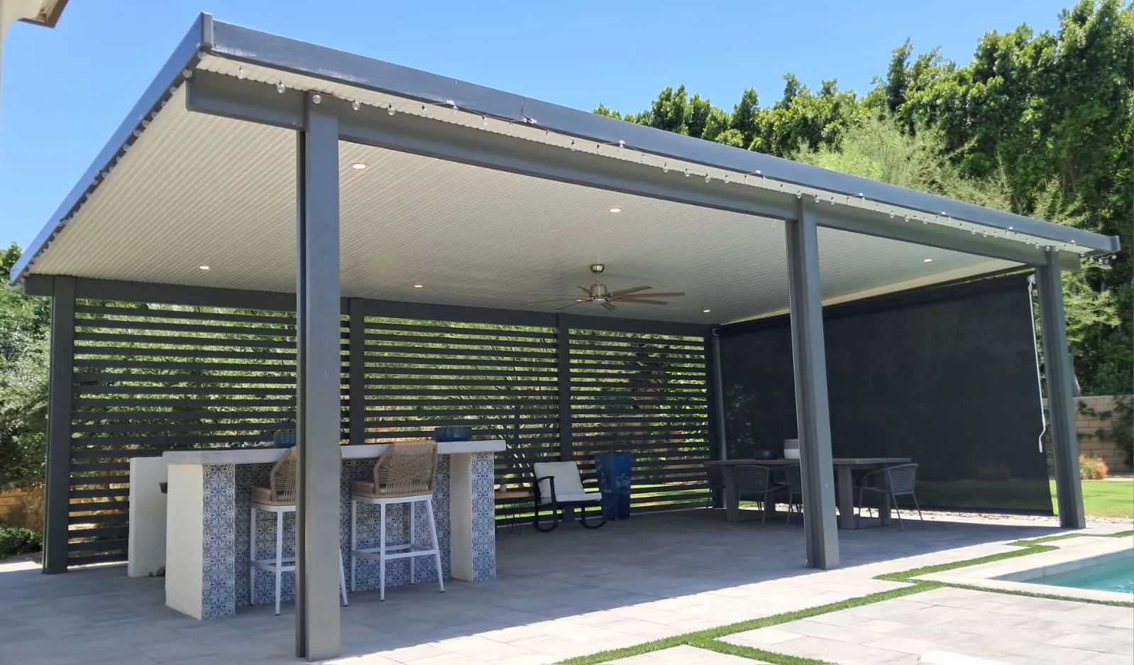 Freestanding solid patio cover with privacy wall and screen enclosure